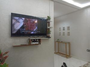 a flat screen tv hanging on a wall at Golden Mirage in Fez