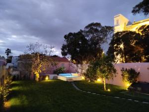 a backyard with a swimming pool at night at Ajuda Palace Inn Lisbon Apartments in Lisbon