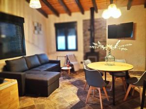 a living room with a couch and a table at Villa pose in Robledillo