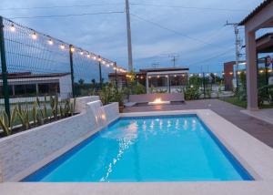 a swimming pool in a backyard with lights on it at Amaia Beach House in El Chirú