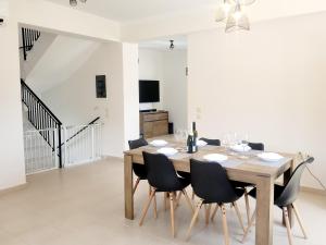 a dining room with a wooden table and chairs at Villa Maritsá in Pastida