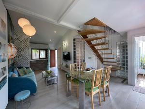 a living room with a blue couch and a glass table at Parrot Cage - the Gay Villa in Playa del Ingles