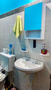 a bathroom with a sink and a toilet and a blue cabinet at Hosteria M.G in Tilcara +17 photos