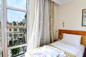 Postel nebo postele na pokoji v ubytování Santa Ottoman Hotel