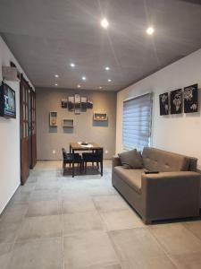 un salon avec un canapé et une table dans l'établissement Balatis Apartamento Ushuaia, à Ushuaia