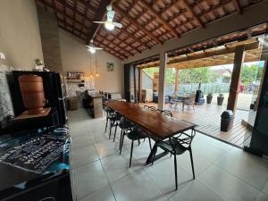 a kitchen and dining room with a wooden table and chairs at Tanuri in Itapoa