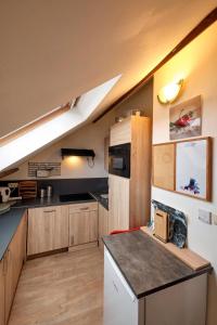 a kitchen with wooden cabinets and a counter top at Friend House in Brussels