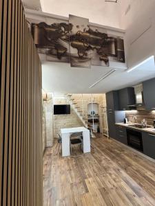 a kitchen with a white table in a room at Quarata Apartment Corato mini appartamento in Corato +13 photos
