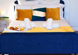a blue and white bed with a tray of food on it at Le Charme D'Antan - Terrasse - Balcon - Hypercentre Evreux in Évreux