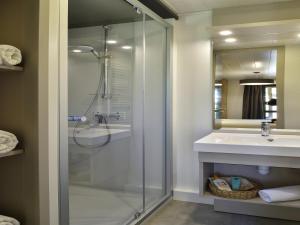 a bathroom with a glass shower and a sink at Chalet in Propriano near Sandy Beaches in Propriano