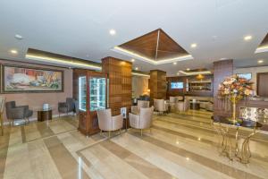 a lobby of a hotel with chairs and a bar at Bekdas Hotel Deluxe & Spa in Istanbul