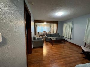 a living room with a couch and chairs and a table at Comfy getaway at falls! in Niagara Falls