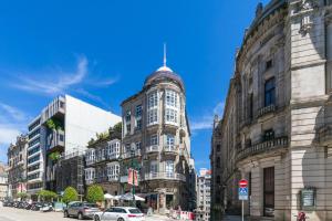an old building with a turret on a city street at Ático Dúplex con Terrazas Privadas Vigo Centro 2 hab ツ by Rias Baixas Rentals in Vigo +56 photos