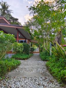 a stone path leading to a house at Mook Paradise Bungalow in Koh Mook