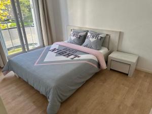 a bed in a room with a large window at Appart Orleans Gare in Orléans