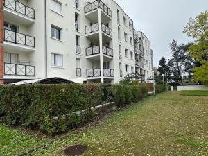 a large white building with balconies on it at Appart Orleans Gare in Orléans