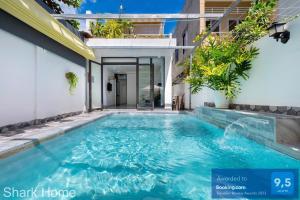a swimming pool in the backyard of a house at Shark Home Vũng Tàu 117 PCT in Vung Tau