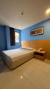 Postel nebo postele na pokoji v ubytování South of The Clouds HOTEL KL Sentral 吉隆坡彩云之南酒店-中央车站店