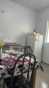 a kitchen with a table and chairs with a table and a table at Apto 104 Flamingo, 1P, Único in Pato Branco