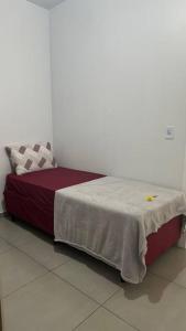a bed sitting in a room with avertisement at Apto 104 Flamingo, 1P, Único in Pato Branco