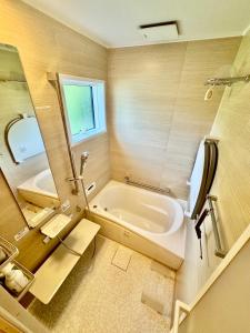 a bathroom with a bath tub and a sink at SNUG CAMP HOUSE in Okubo +34 photos