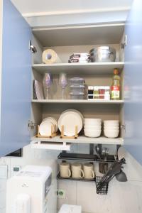 ソウルにあるCity Hall,Central Seoul apartmentのキッチンパントリー(皿、棚の上の食器付)