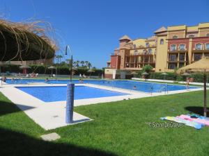 a swimming pool in front of a large building at CostaOro in Torrox Costa