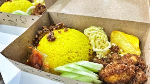 a box filled with different types of food at Villa LA Mansion Lembang - 2BR for 2-6 Guest stay in Lembang