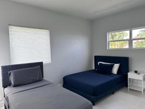 a bedroom with two beds and a window at The Luxury Escape in Rouarné +16 photos