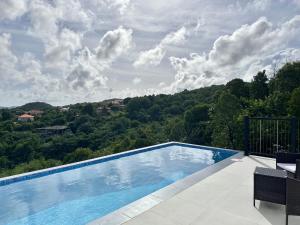 a swimming pool with a view of a mountain at The Luxury Escape in Rouarné