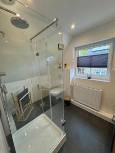 a bathroom with a glass shower and a sink at Pension Jaeger in Achim +3 photos