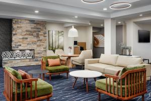 a lobby with a couch and chairs and a fireplace at Fairfield Inn and Suites by Marriott Birmingham / Bessemer in Bessemer