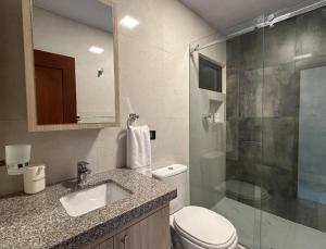 a bathroom with a toilet and a sink and a shower at C 1 - Cálido depto Edif Alfas cambio paralelo in Tarija