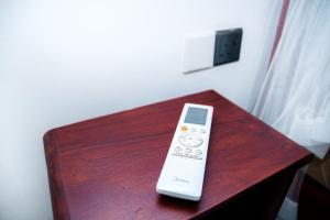 a remote control sitting on top of a wooden table at River Relax Villa in Ahangama