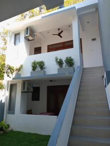 a stairway leading up to a white house at Villa 58 Unawatuna in Unawatuna
