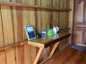 a wooden table in a sauna with a laptop on it at Mukakee 3-4 in Ban Sop Mae Klang