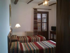 Postel nebo postele na pokoji v ubytování Hostal Rural Poqueira