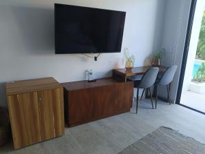 a living room with a flat screen tv on a wall at luxury central park lagunas in Tulum