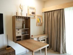 a room with a table and a shelf and a window at Kudrats Nook -Seaview Bohemian Studio in Canacona