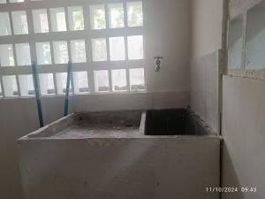an empty room with a tub in front of a window at La Casa de Doña María in Mariquita +17 photos