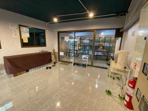 an empty room with a large window and a table at Sleep At Home - Don Mueang in Ban Ko
