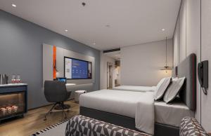 Ein Bett oder Betten in einem Zimmer der Unterkunft Holiday Inn Express Zhengzhou Nongye Road by IHG