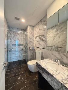 a bathroom with a toilet and a sink and a shower at Facestyle Infinity Pool KLCC Smart TV Free WiFi Two Bedroom in Kuala Lumpur