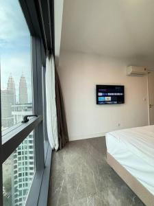 a bedroom with a bed and a large window at Facestyle Infinity Pool KLCC Smart TV Free WiFi Two Bedroom in Kuala Lumpur
