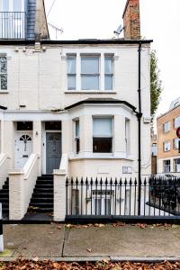 a white brick house with a black fence at HARU Residence, 5bed Luxury House in London