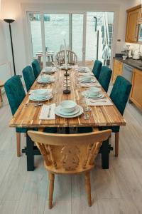 a dining room table with chairs and a wooden tableablish at HARU Residence, 5bed Luxury House in London