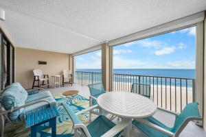 a balcony with a table and chairs and the ocean at Bluewater Vacation Rentals in Orange Beach +184 photos