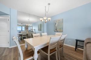 a dining room with a table and chairs at Bluewater Vacation Rentals in Orange Beach