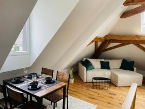 a living room with a table and a couch at Appartement "Villa Seeliebe" in Tägerwilen