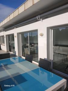 a house with a blue table and chairs on a balcony at Appartement Almadrava Roses in Roses